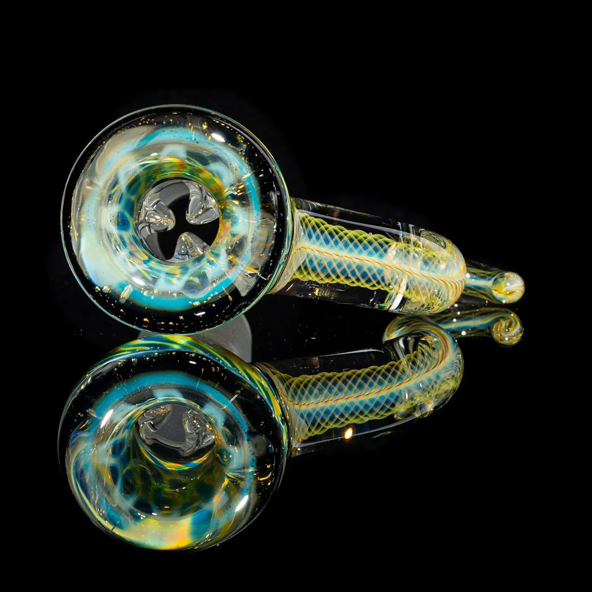 Colorful hand-blown glass pipe with swirl patterns reflected on black surface