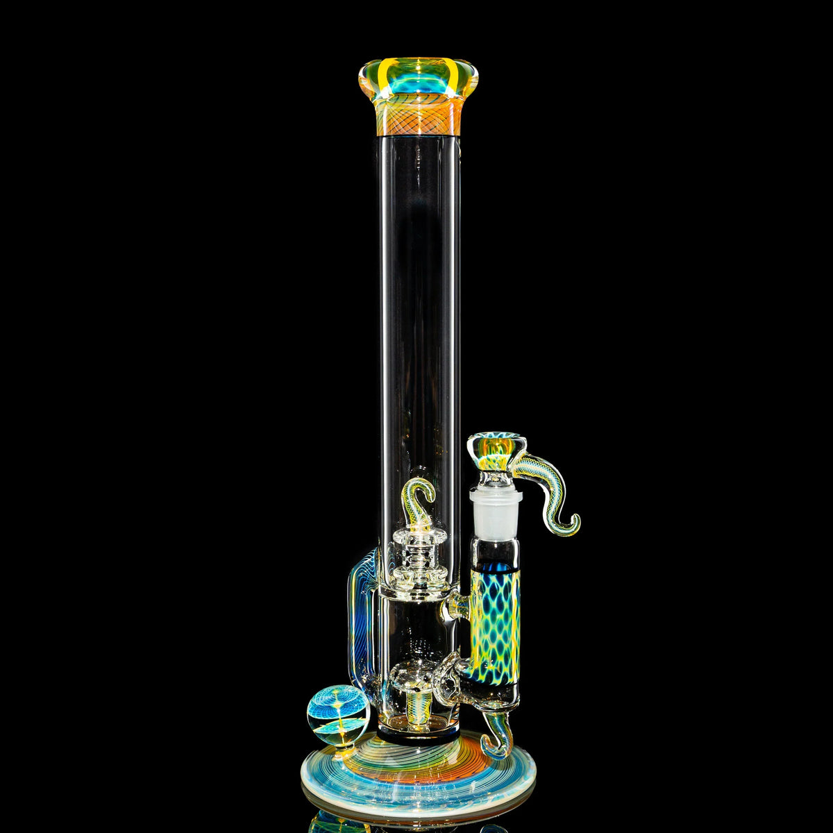 Colorful heady glass water pipe with intricate patterns and marble accent on black background