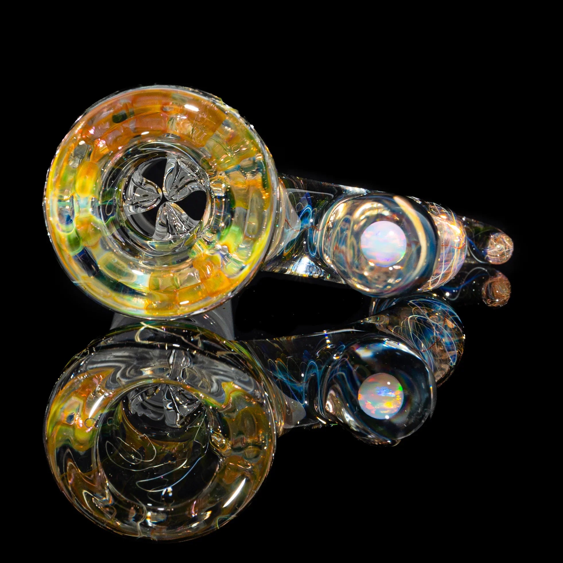 Colorful glass hand pipe with opal accent, shown on a reflective black background