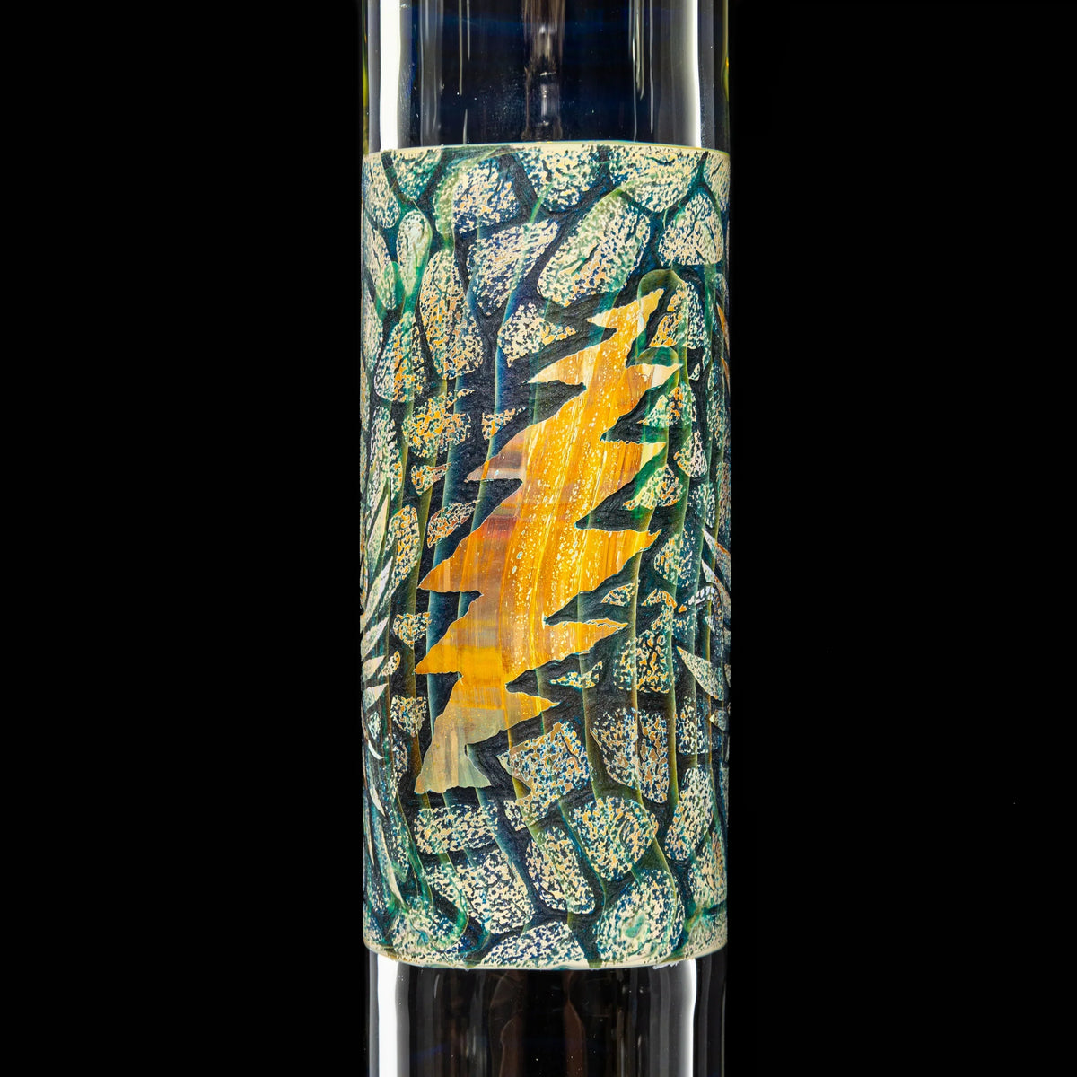 Close-up of a glass water pipe with intricate tree and stone pattern design.