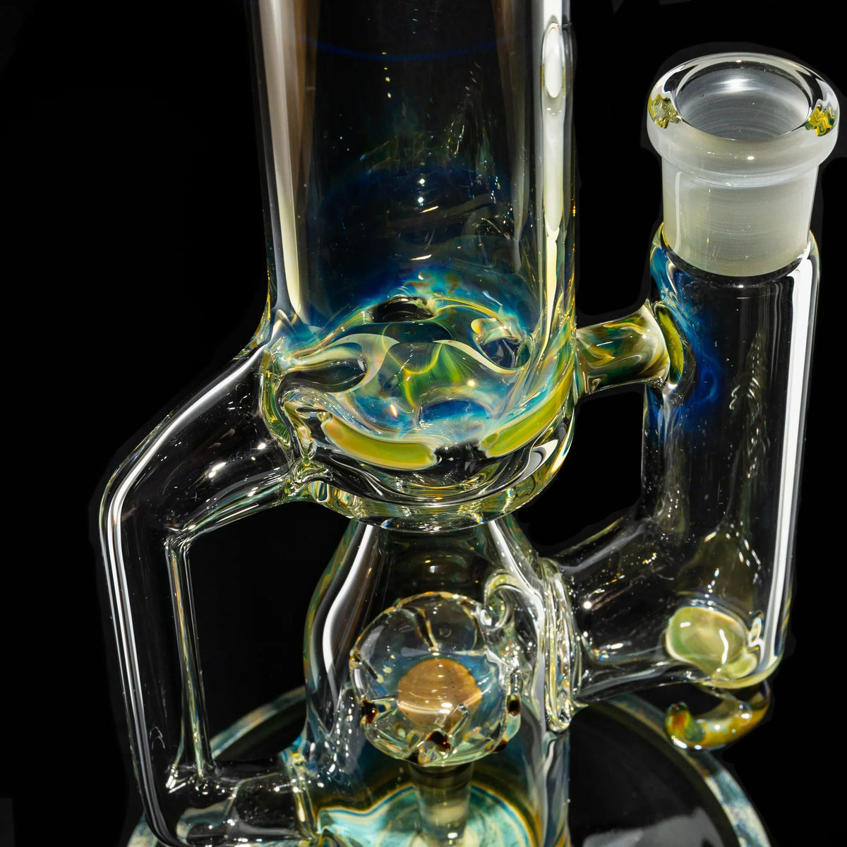 Close-up of a heady glass water pipe with intricate design and colorful accents