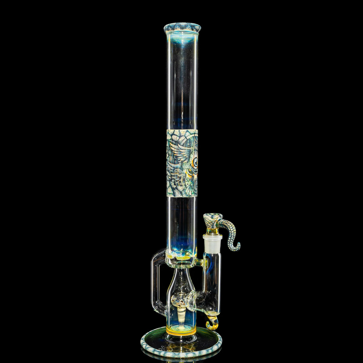 Intricate glass water pipe with artistic owl and snake designs, displayed on black background.