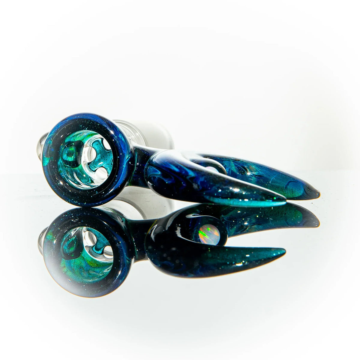 Blue and green glass pipe with opal accent and unique claw design, reflected on white background