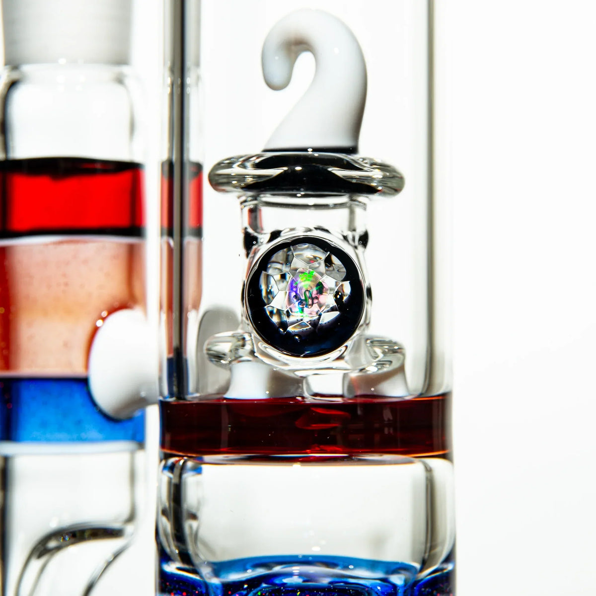 Close-up of a colorful glass water pipe with intricate marble and swirled accents