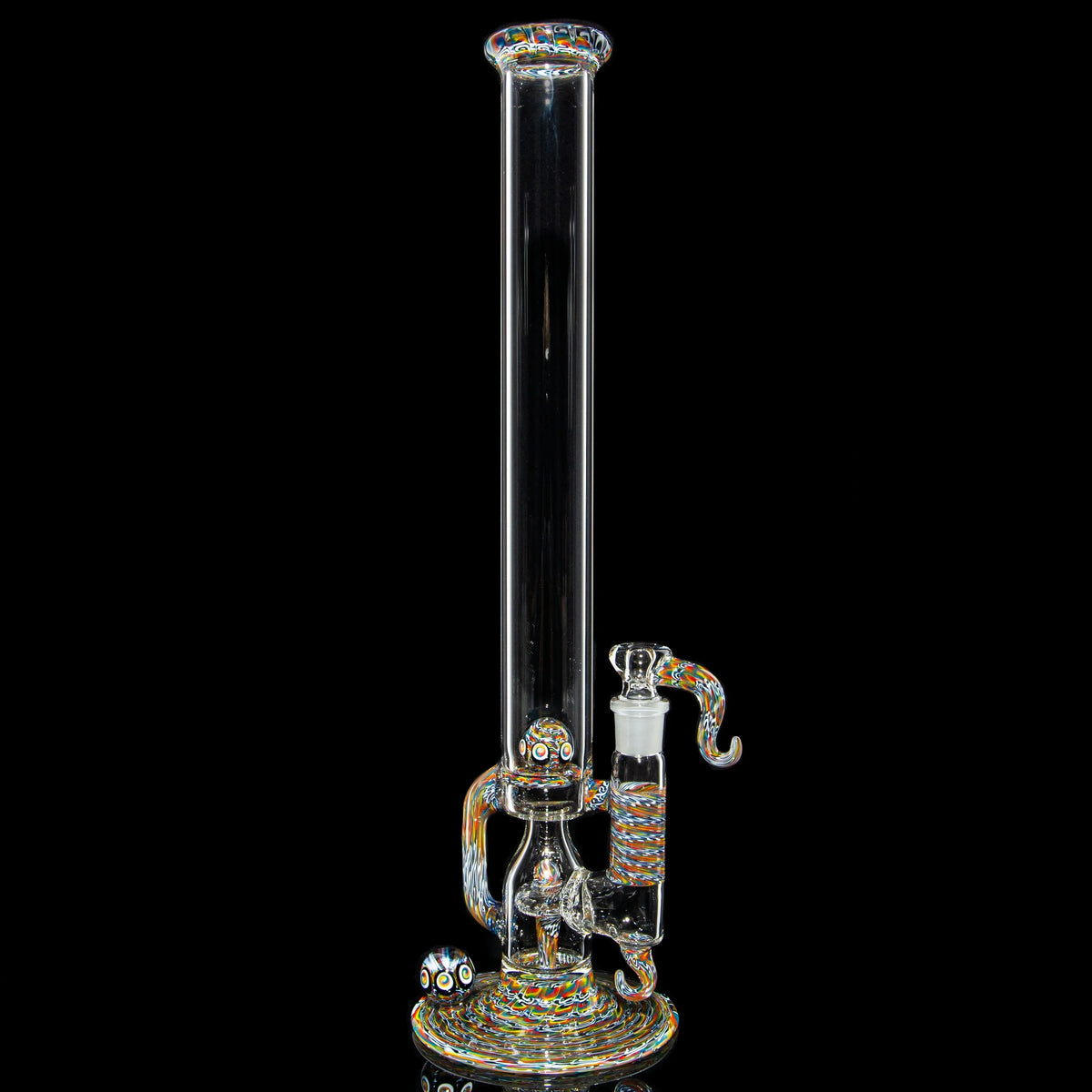 Heady glass water pipe with colorful accents and intricate patterns on a black background