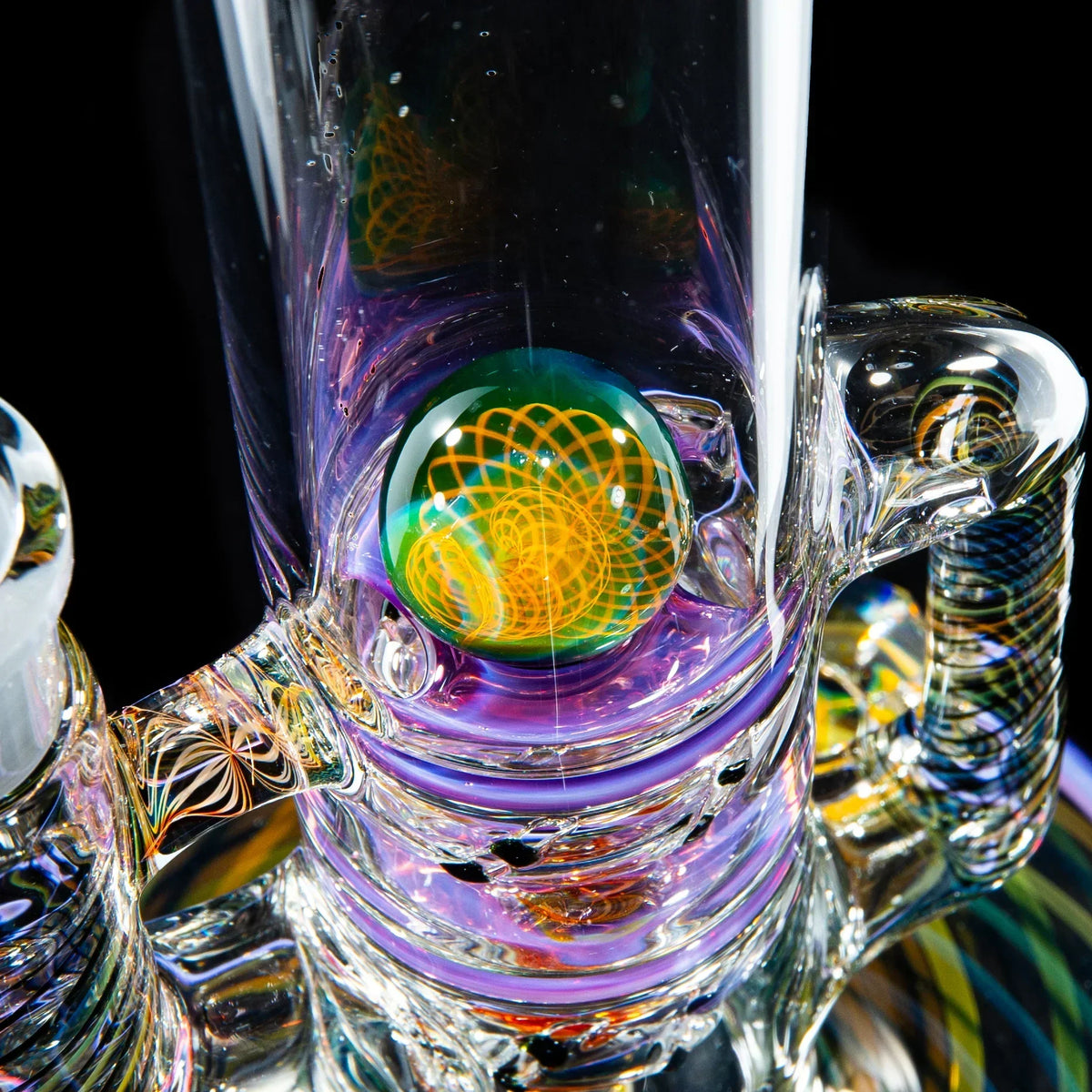 Close-up of a colorful heady glass water pipe with intricate marble and swirling designs