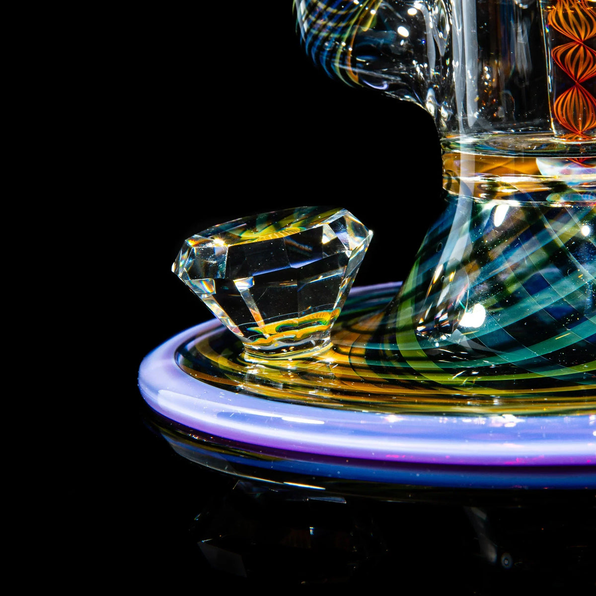 Close-up of a colorful heady glass water pipe with diamond-shaped accent, glass art detail