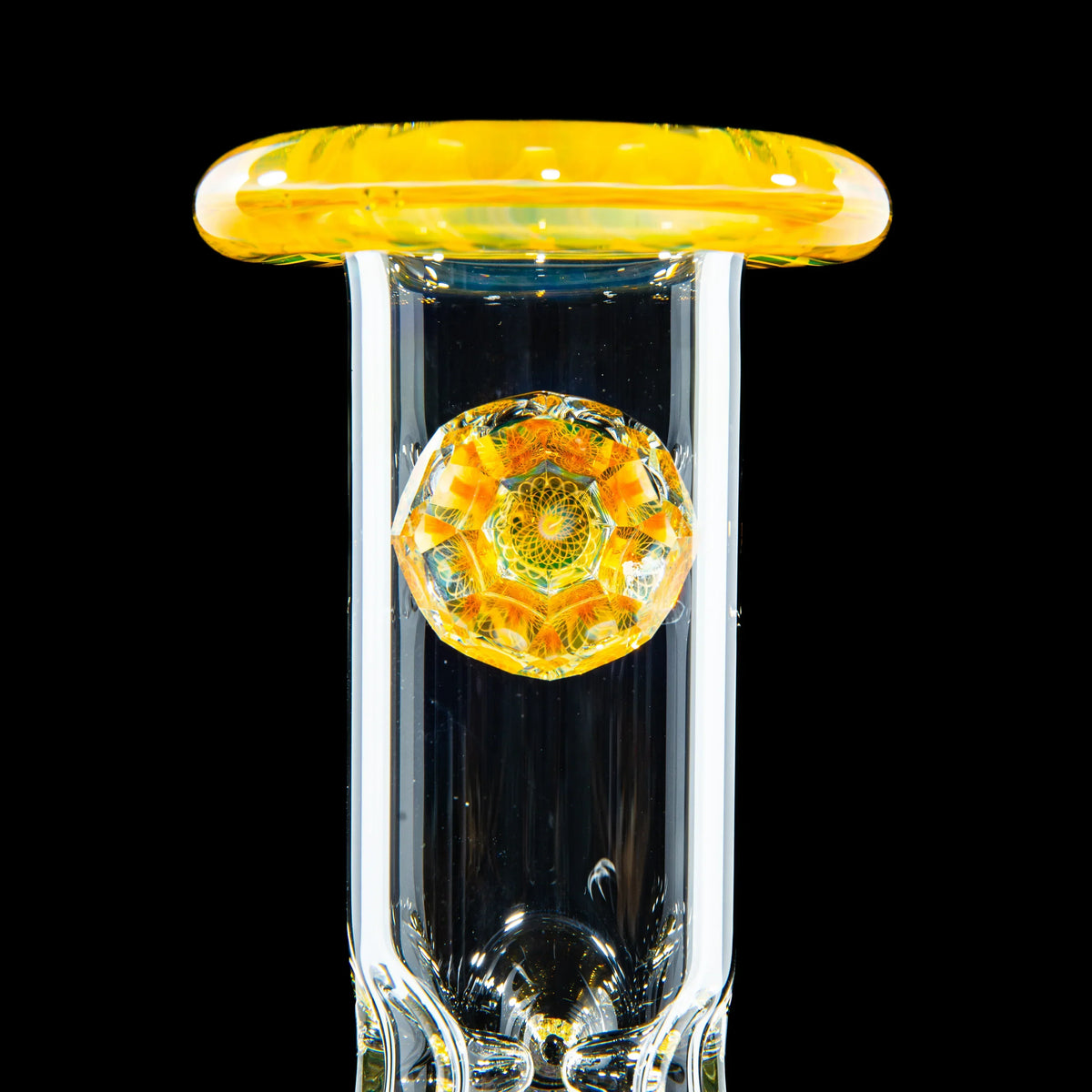 Artistic glass bong with intricate yellow and orange mandala accent on a clear tube