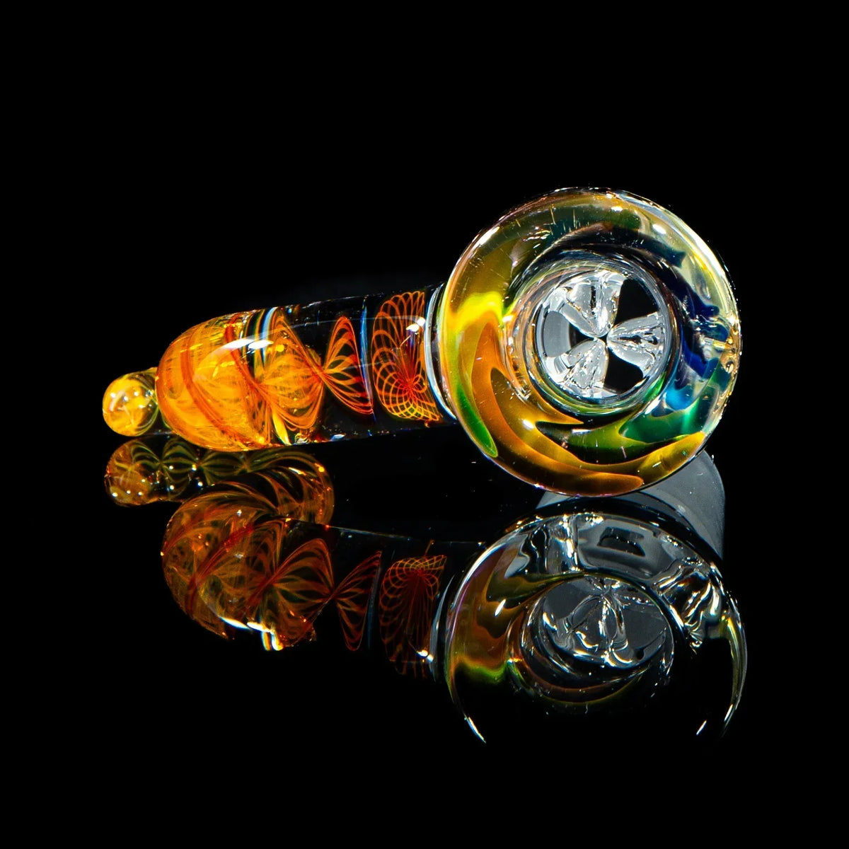 Colorful glass hand pipe with intricate orange and yellow spiral design on black background