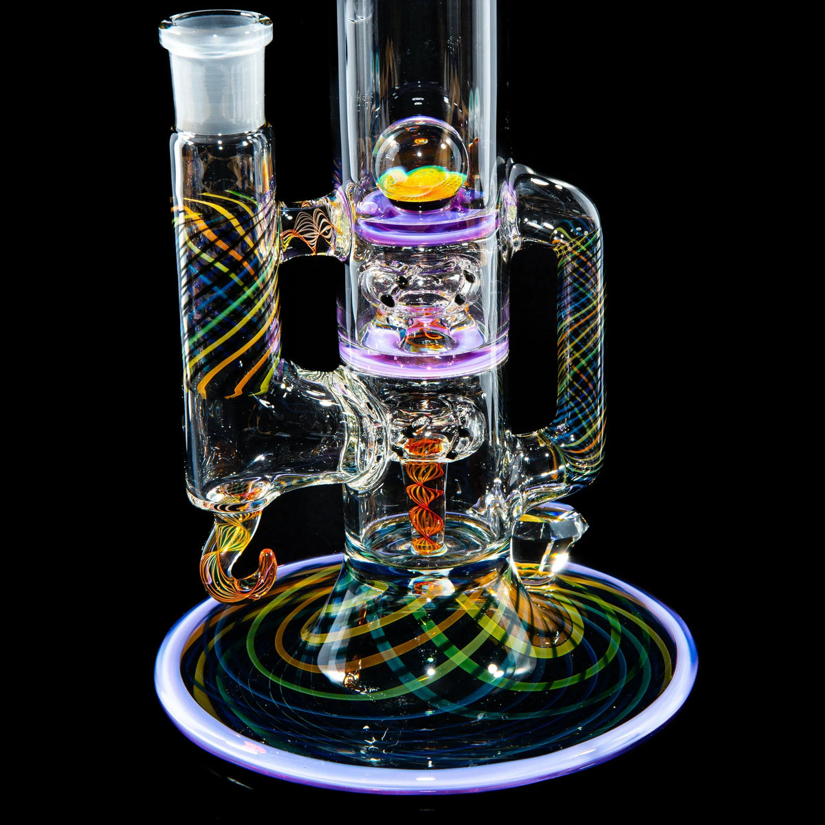 Colorful heady glass water pipe with intricate swirling patterns and UV accents