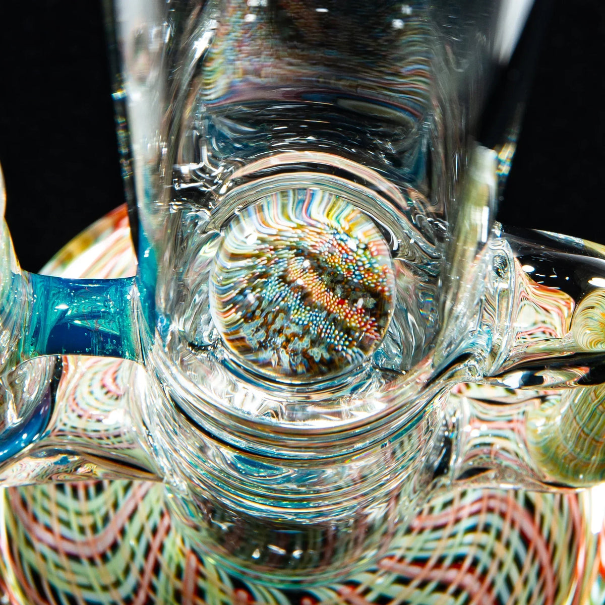 Close-up of a glass water pipe with intricate colorful patterns and detailed glasswork.