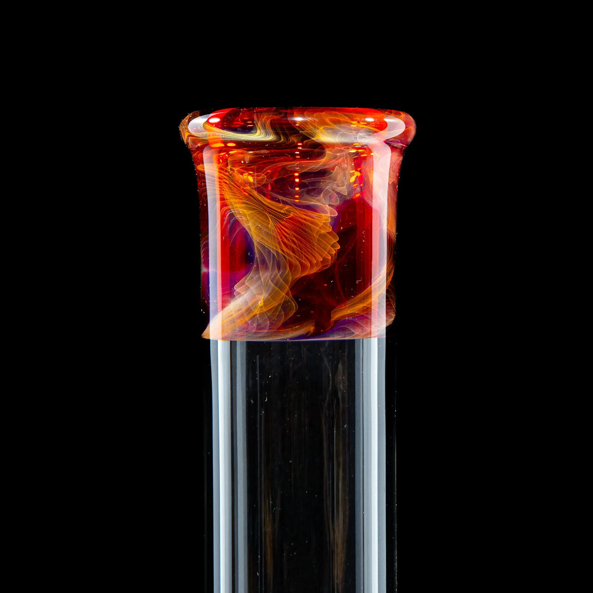 Colorful borosilicate glass pipe with vibrant red and orange swirl accents on black background