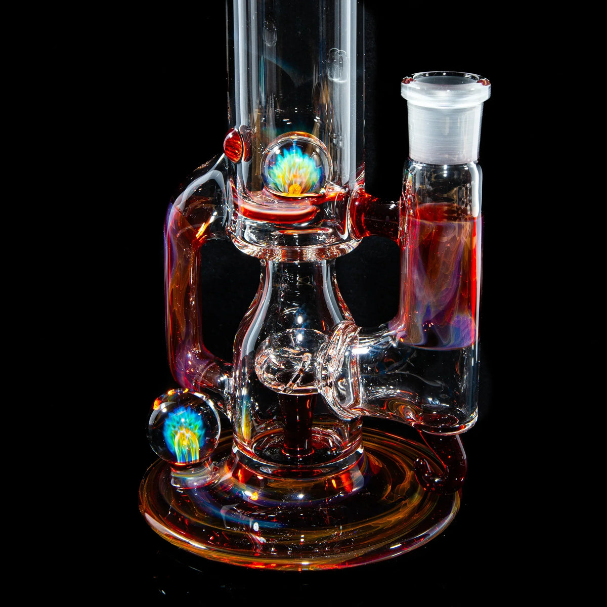 Heady glass water pipe with colorful marble and intricate design on black background