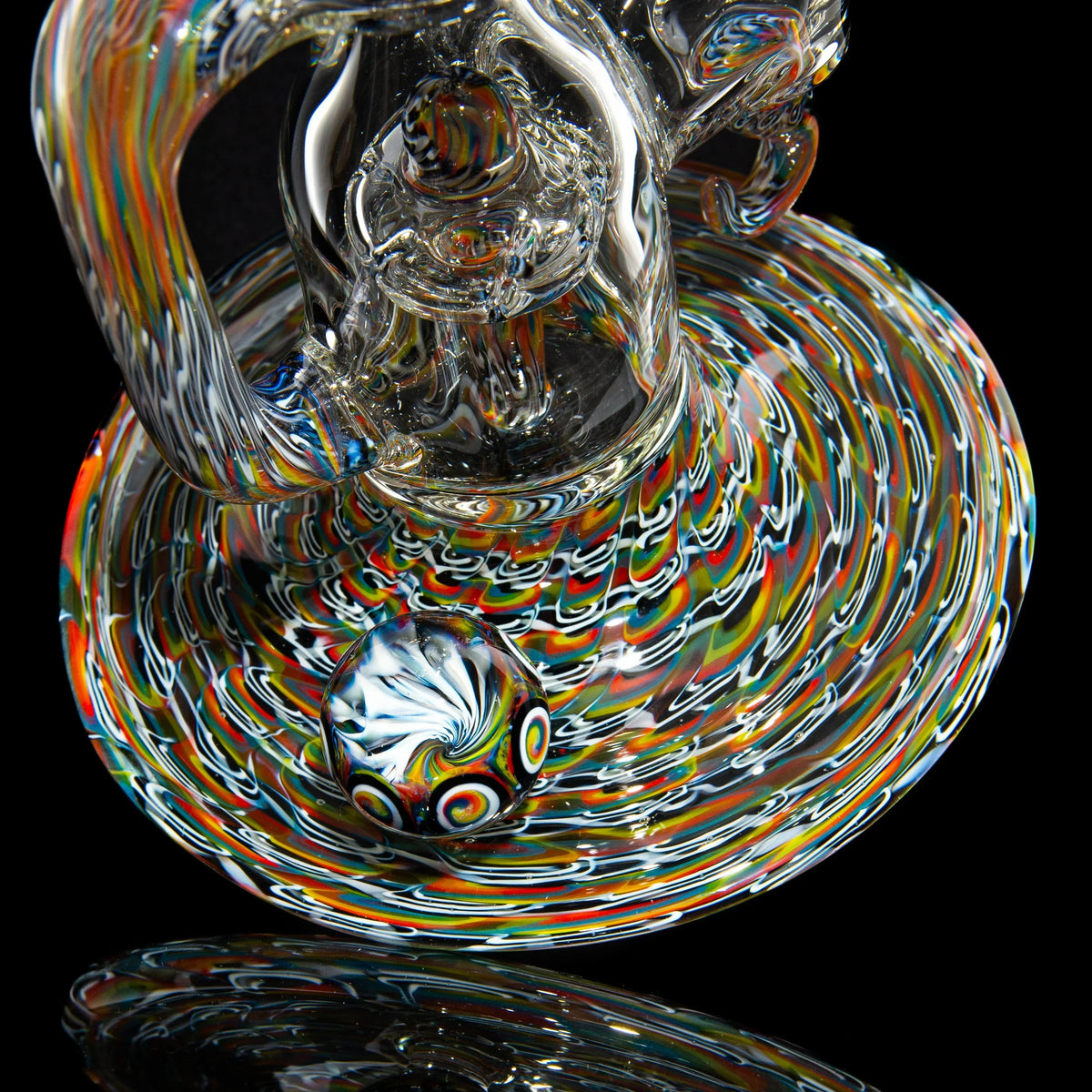 Colorful heady glass water pipe with intricate, swirling patterns and a matching marble base