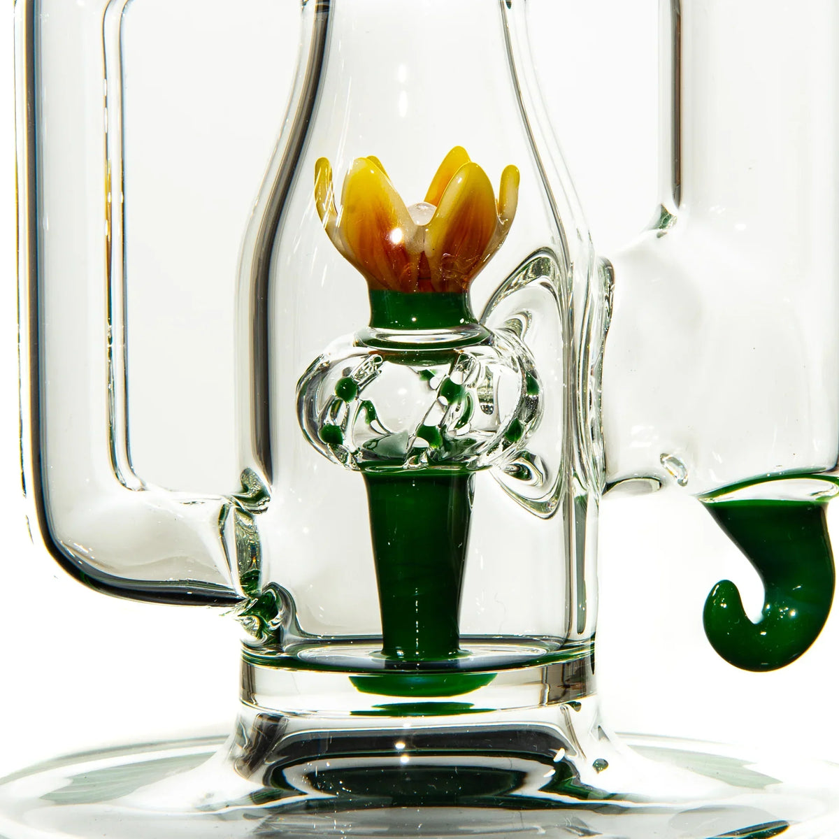 Close-up of glass water pipe with cactus and flower-shaped detail in the chamber