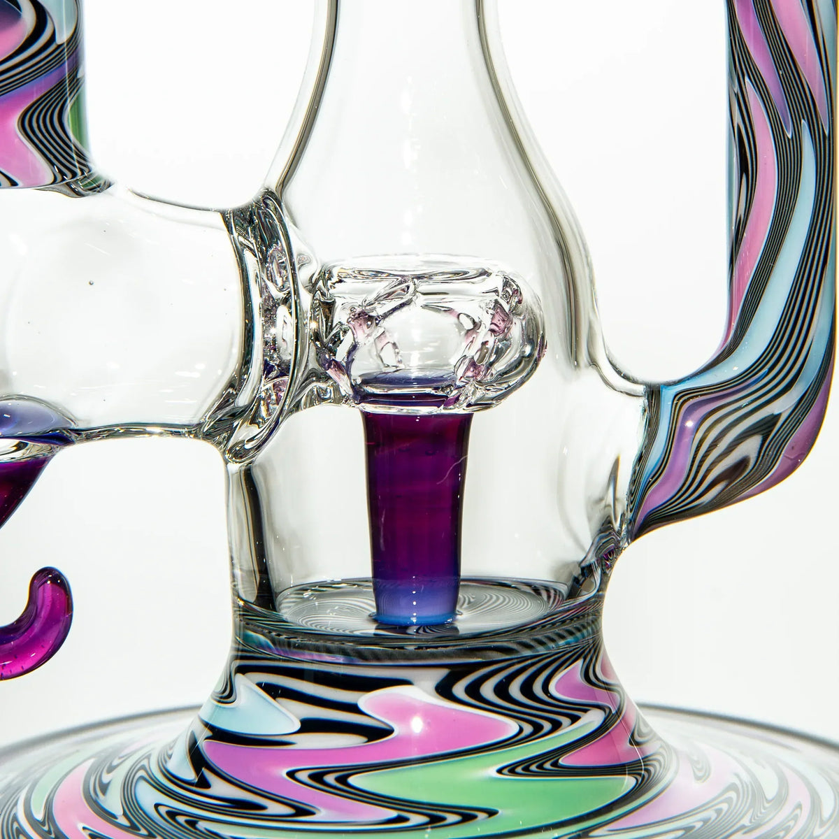 Close-up of colorful glass water pipe with psychedelic swirl patterns and clear glass details.
