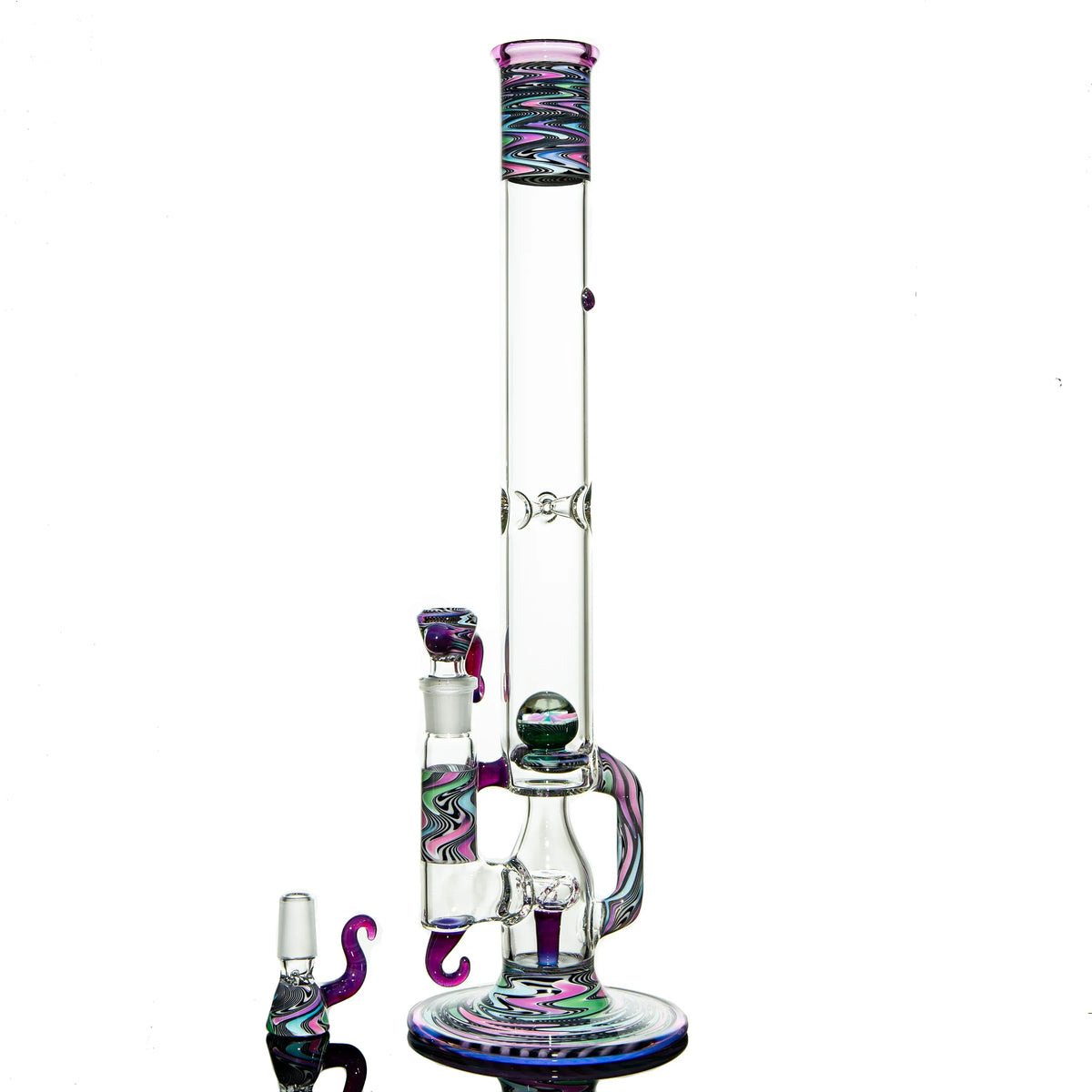 Heady glass water pipe with colorful swirl accents and matching accessories on white background