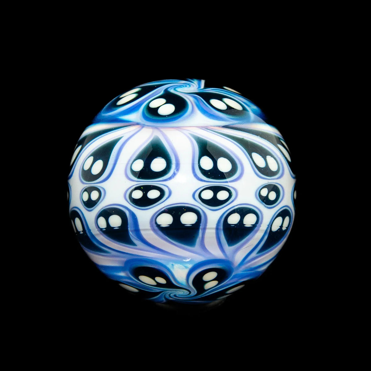 Heady glass marble with intricate blue and white swirling patterns and ghost-like designs