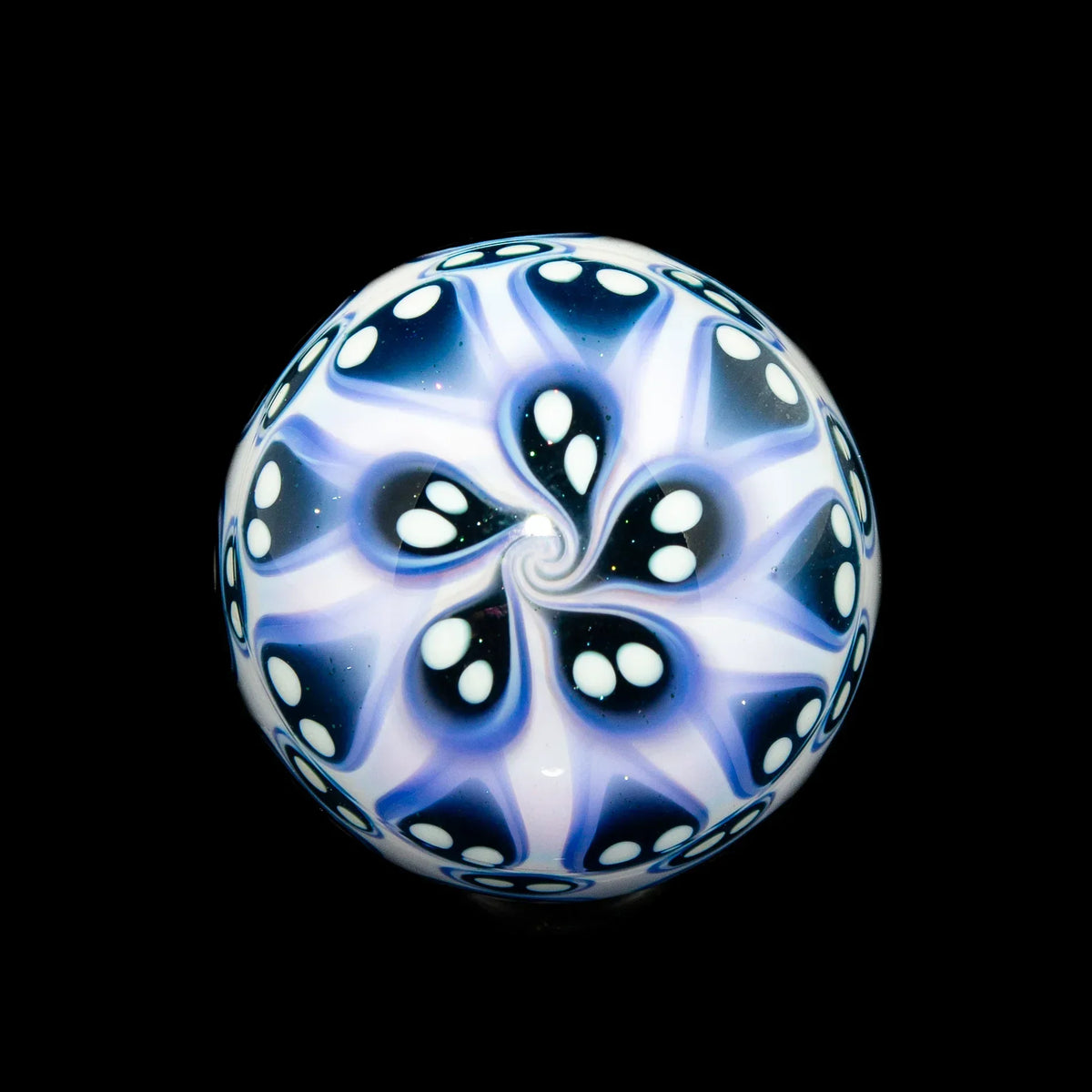 Blue and white glass marble with intricate flower petal pattern on black background