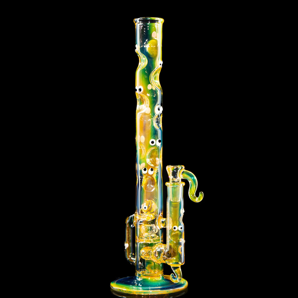 Colorful heady glass water pipe with eye accents and unique wavy design on black background