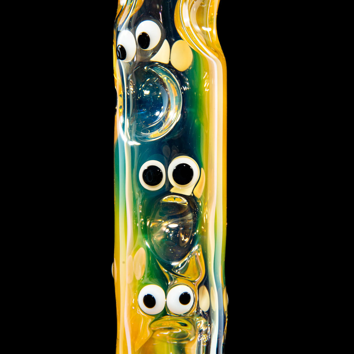 Colorful hand-blown glass pipe with cartoon eyes and unique sculpted details