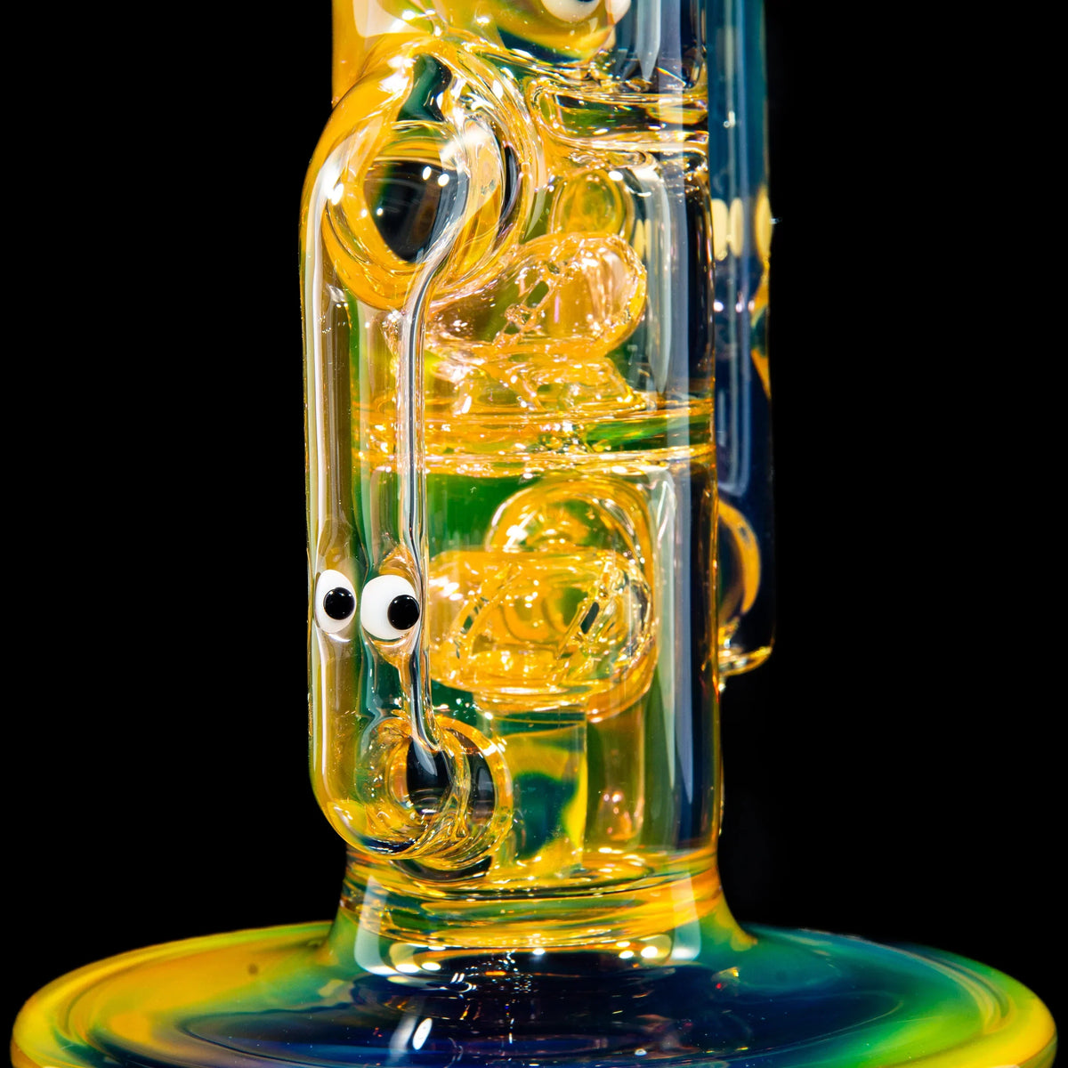 Colorful heady glass water pipe with intricate details and whimsical face accents