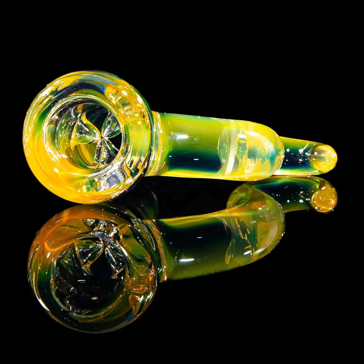 Yellow green glass hand pipe with reflection on black background