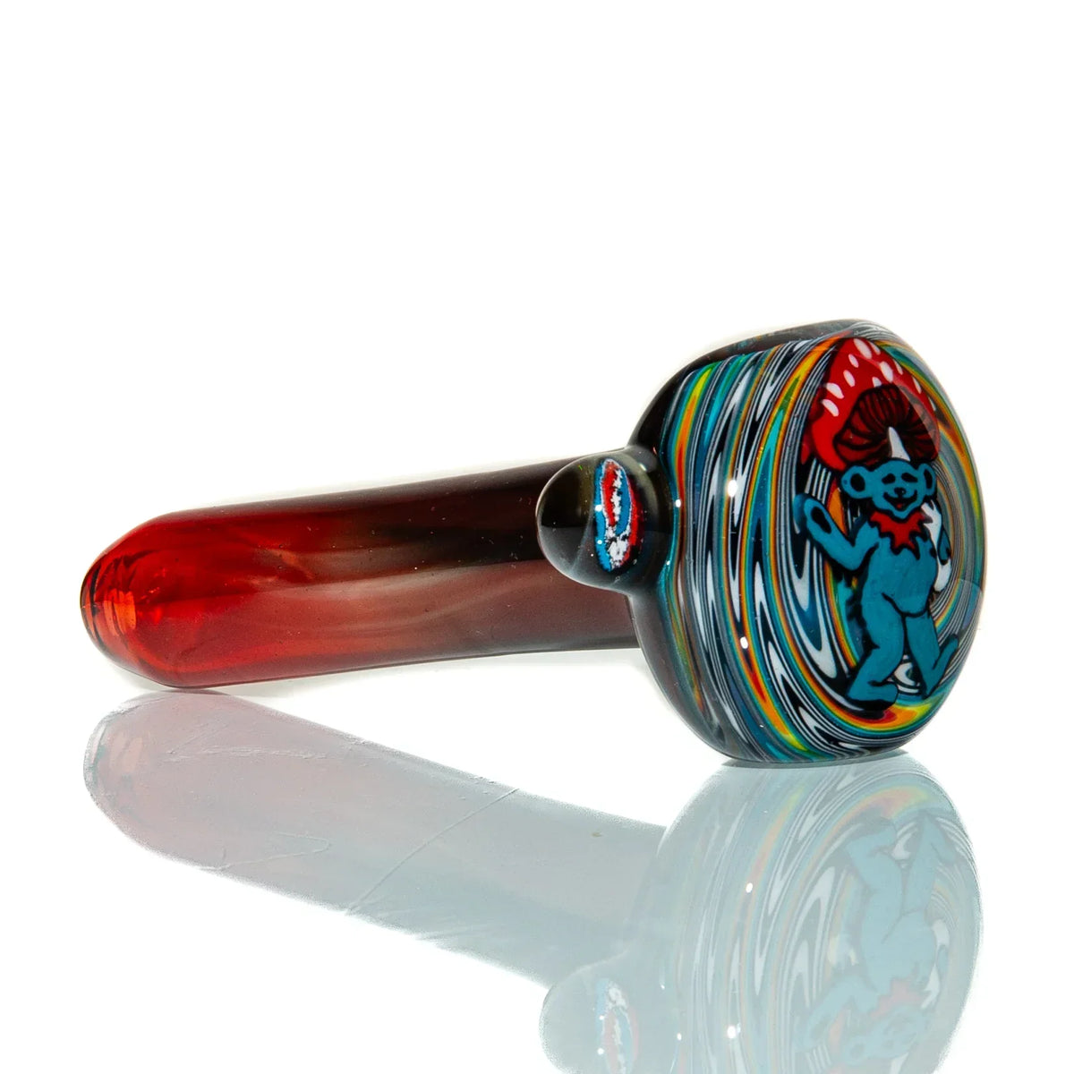 Handcrafted red glass pipe with colorful swirls and a blue bear design under mushroom