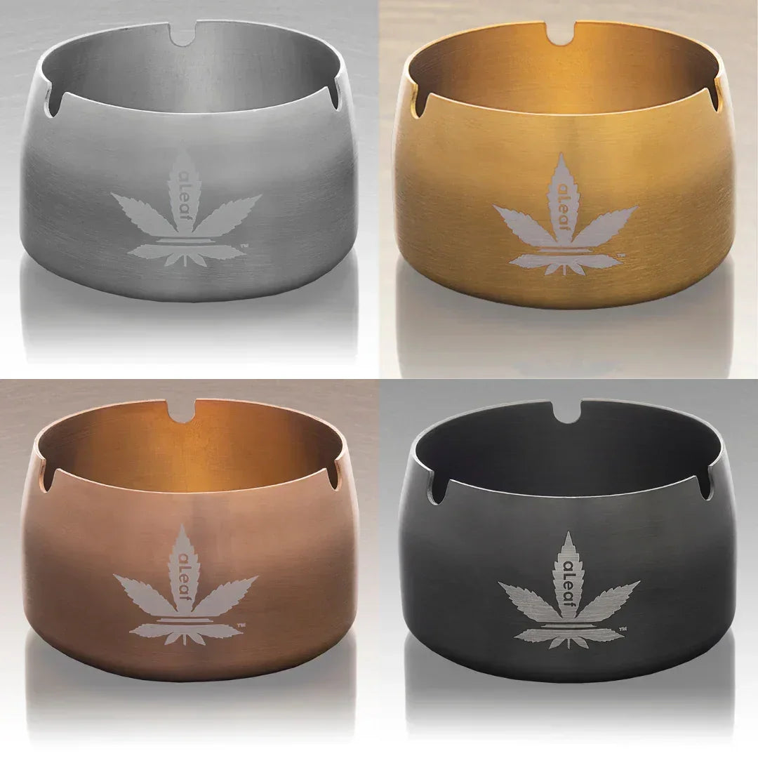 Collage of four metal ashtrays in silver, gold, bronze, and black with leaf designs