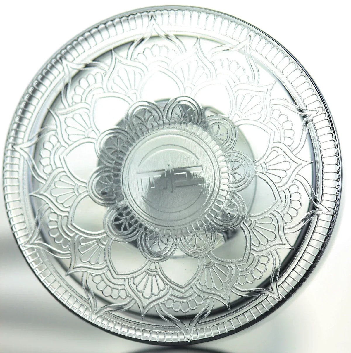 Intricately engraved glass smoke accessory with mandala pattern, viewed from above