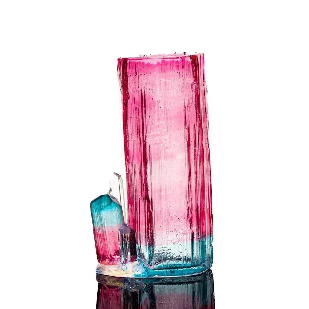Handcrafted glass water pipe with pink and blue crystal-like design, displayed on white background