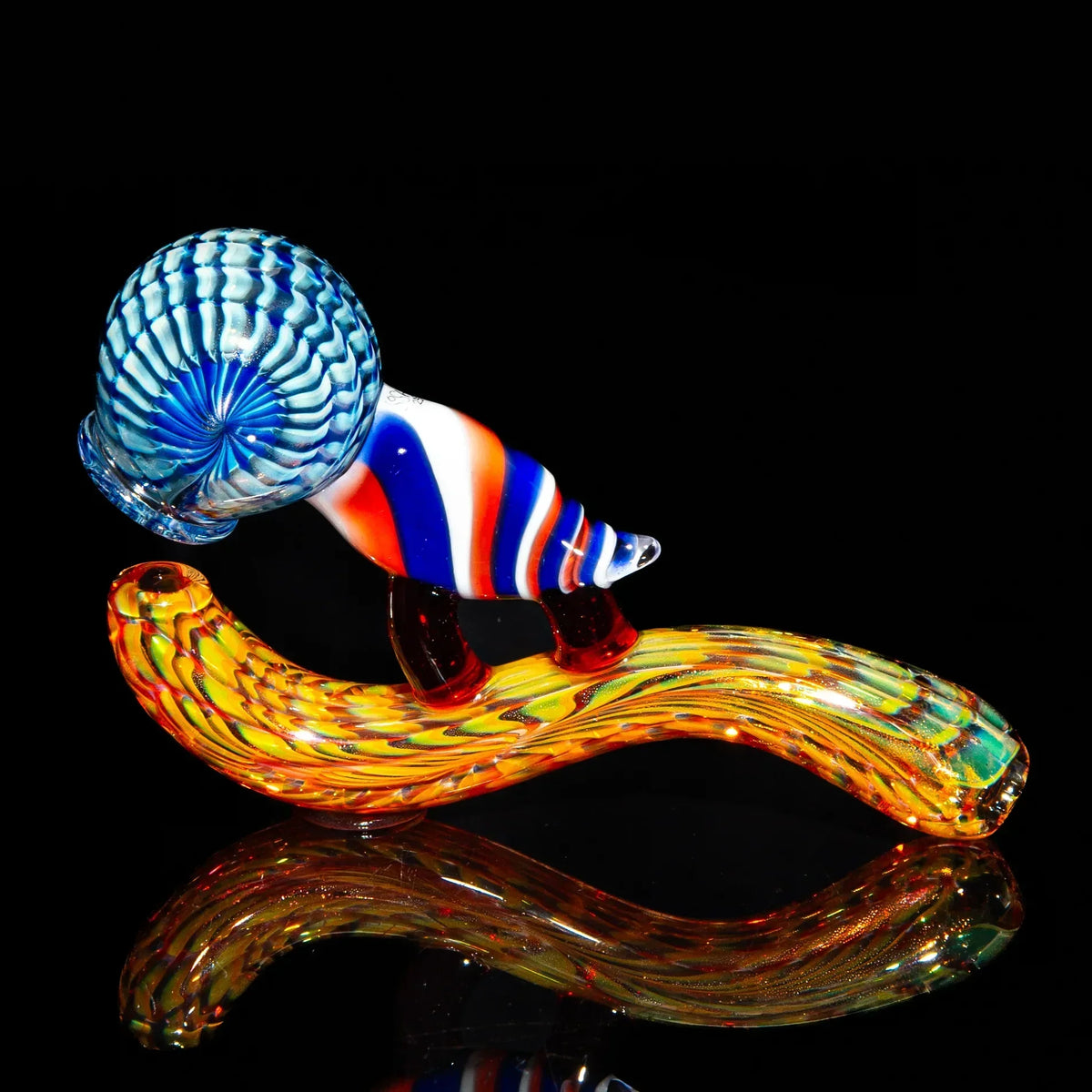 Colorful glass hand pipe shaped like a snail with blue, red, and orange swirl accents