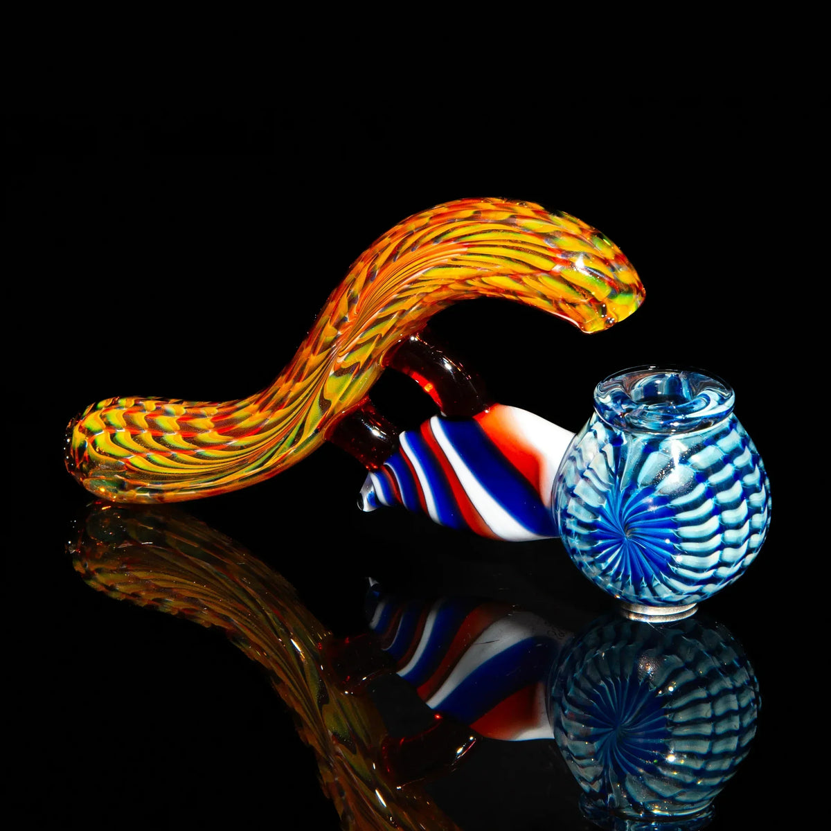 Colorful hand-blown glass pipe with swirling blue, red, and orange patterns on a black background.