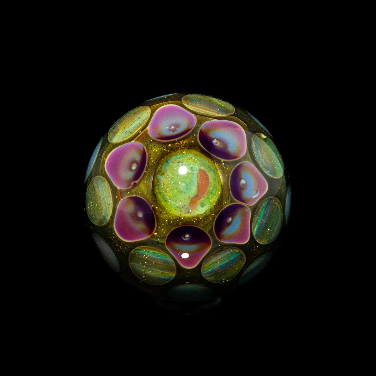 Colorful glass marble with iridescent dots and gold sparkles on black background
