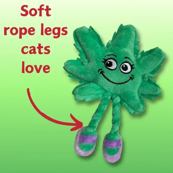 Green plush cat toy shaped like a leaf with soft rope legs and smiling face on light green background.