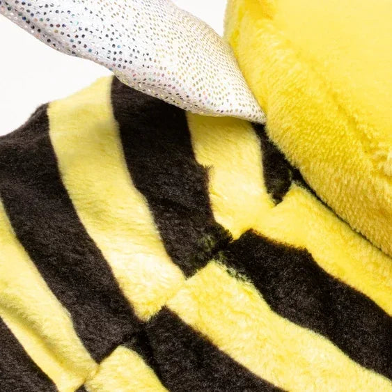 Close-up of plush bee toy with yellow and black stripes and a glittery wing
