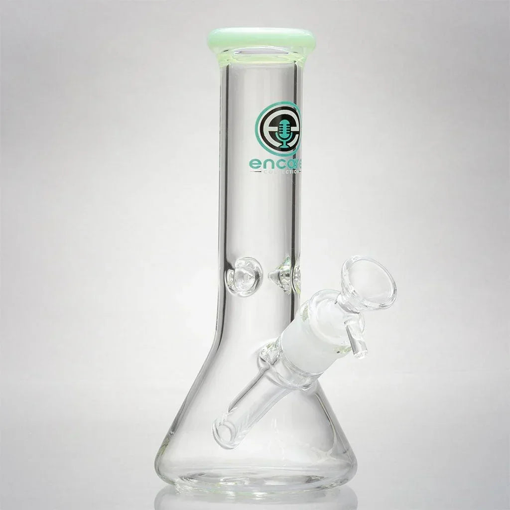 Clear glass beaker mini bong with Encore logo and green-tinted mouthpiece on white background.