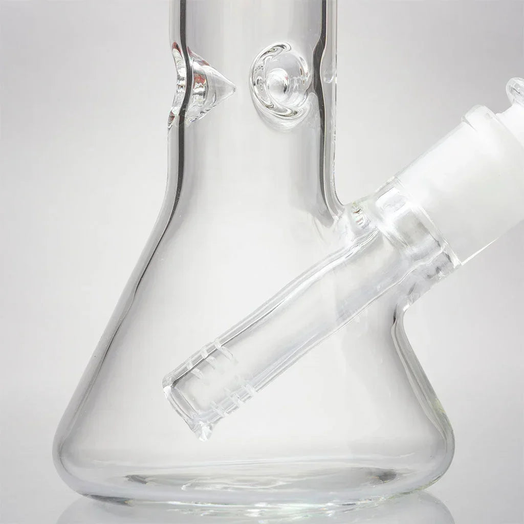 Clear glass mini beaker bong with downstem, close-up on smooth base and joint.