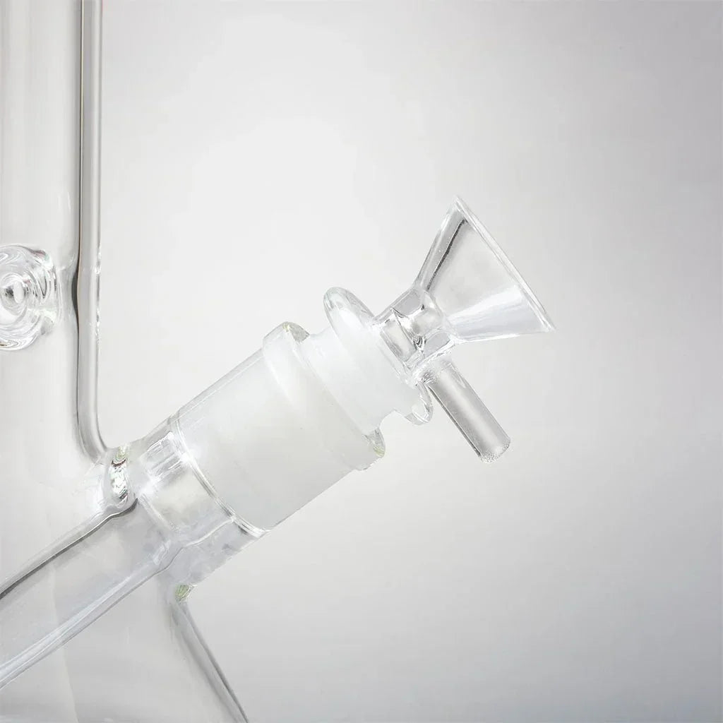 Close-up of a clear glass mini beaker water pipe with removable bowl and downstem.
