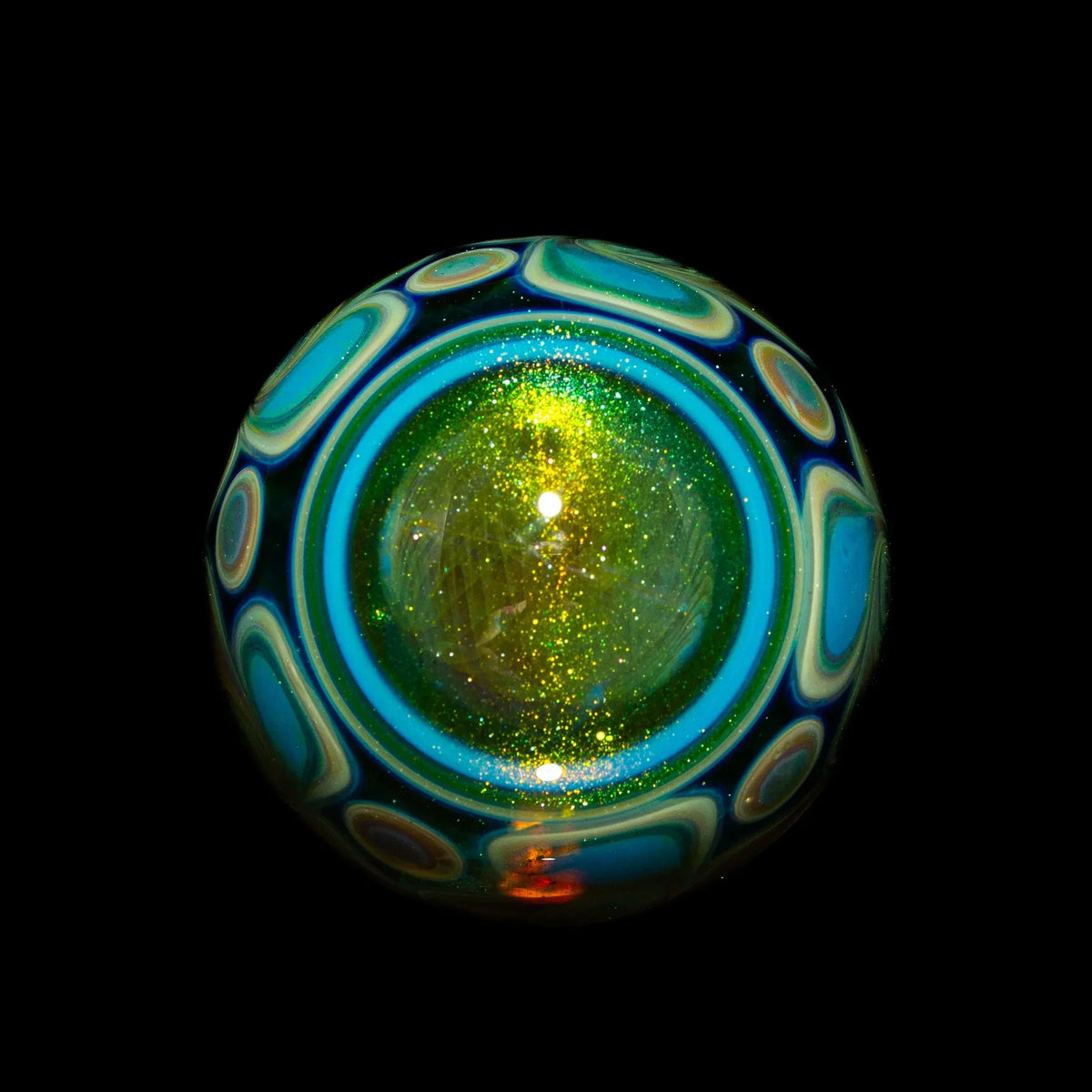 Handcrafted glass art marble with sparkling green center and blue patterned swirl design