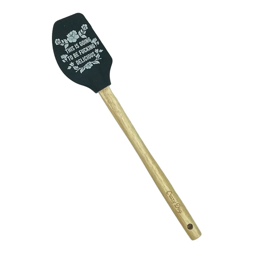 Black silicone spatula with wooden handle and humorous engraved quote, kitchen utensil