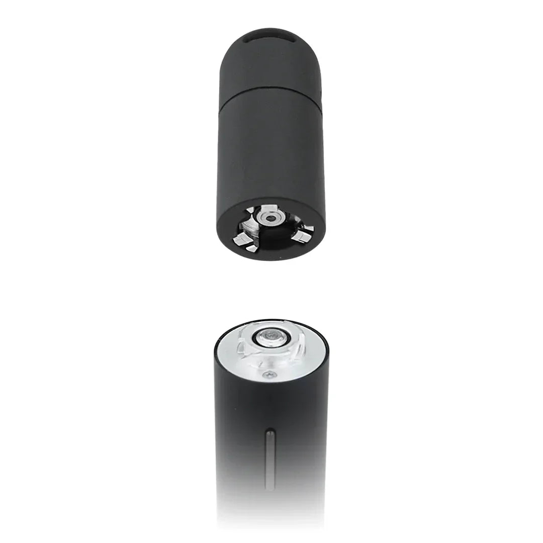 Black electric herb grinder with exposed metal blades, shown separated into two parts.