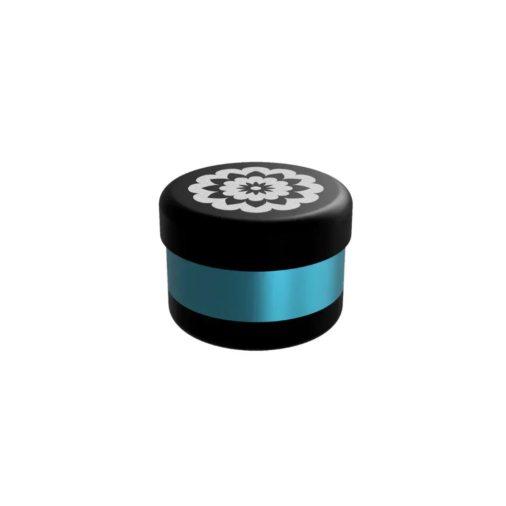 Blue 3-piece herb grinder with flower design on lid, isolated on white background