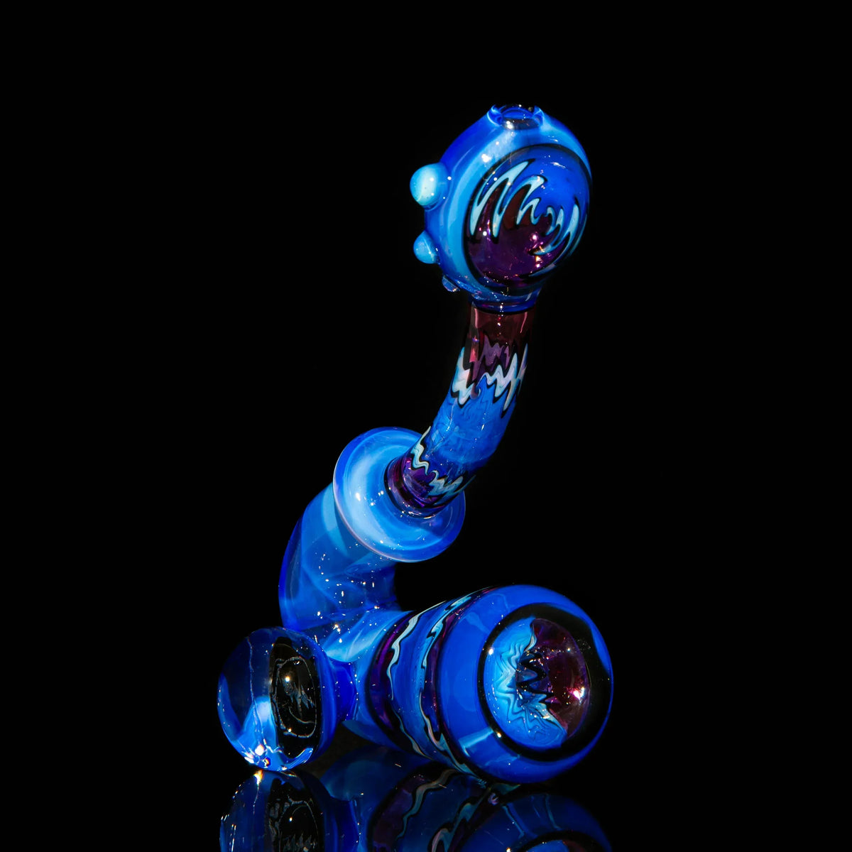 Colorful blue and purple heady glass pipe with intricate patterns on a black background.