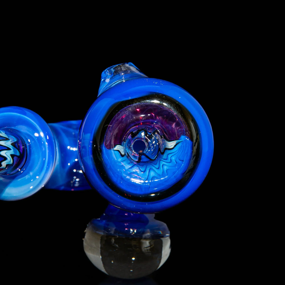Blue heady glass pipe with intricate marble and swirl patterns on black background