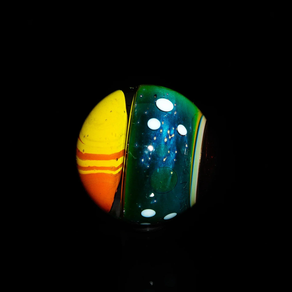 Colorful heady glass marble with yellow, orange, blue, and white dot design