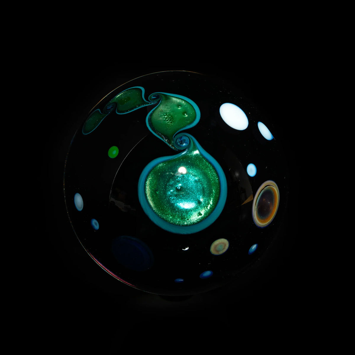 Heady glass marble with cosmic galaxy design, green swirls, and colorful accents on black background.