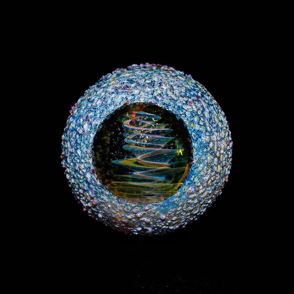 Intricate hand-blown glass marble with textured surface and colorful spiral core