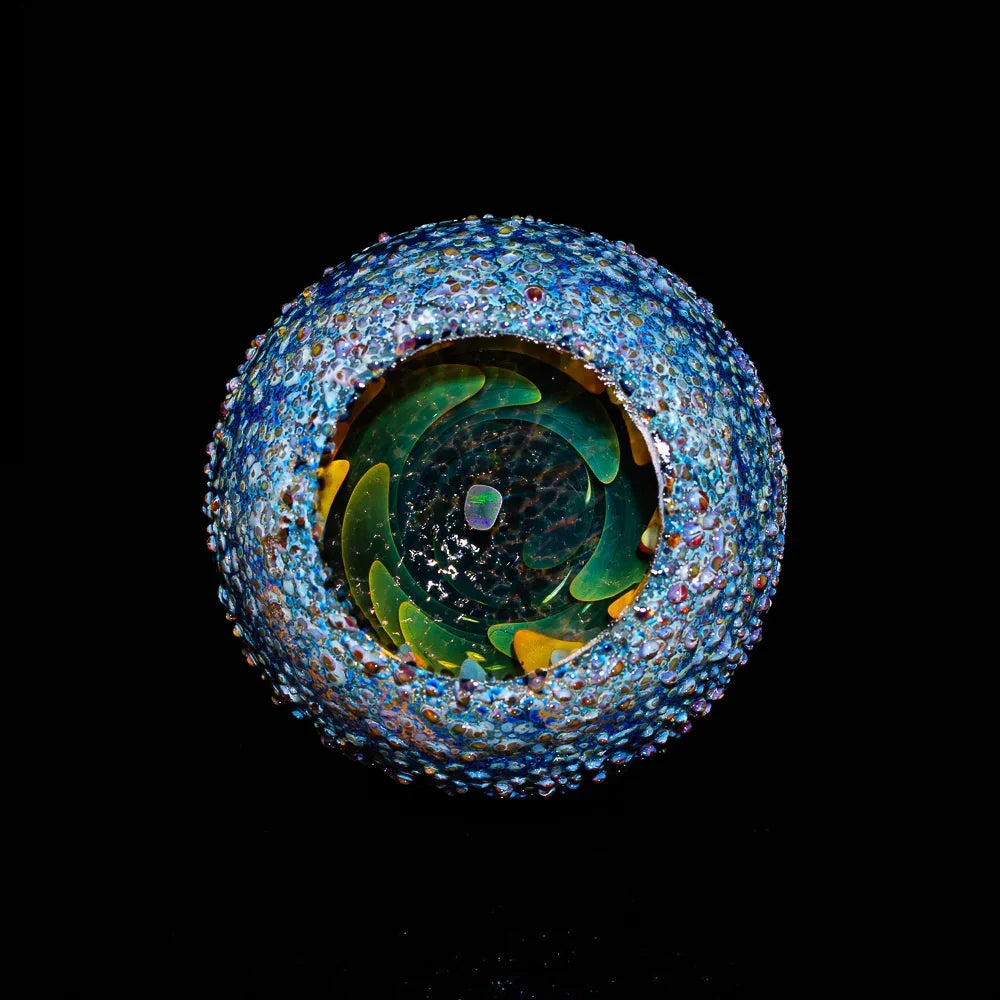 Intricate heady glass marble with colorful textured surface and spiral interior design
