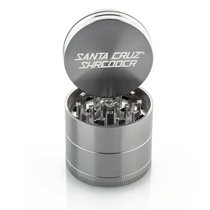 Grey Santa Cruz Shredder metal herb grinder with open lid showing sharp teeth